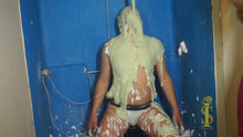 Man in briefs looks up as green slime falls on him from above