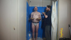 Man holding two pies, second man, holds a third