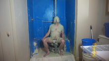 Man sitting with green slime falling on his head and face