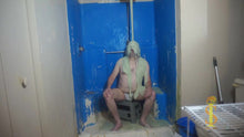 Man sitting with green slime falling on head and face